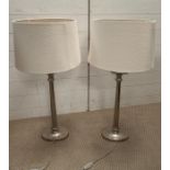 Two contemporary chrome lamps with cream shades