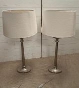 Two contemporary chrome lamps with cream shades