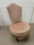 A small bedroom chair on brass castors and mink velvet fabric