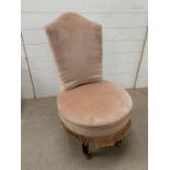 A small bedroom chair on brass castors and mink velvet fabric