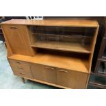 A G-Plan style teak sideboard with glazed shelves (H127cm W138cm D40cm)