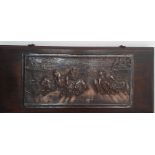A brass relief on wood depicting a quadrigas race, signed: 'P.King' (after engraving) and dated 1909
