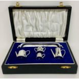A Cased silver miniature tea set by A Chick & Sons Ltd, hallmarked for London 1975