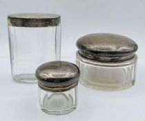Three hallmarked silver topped glass jars.