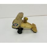 A wind up vintage tin toy of a plane