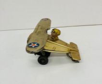 A wind up vintage tin toy of a plane