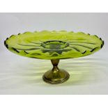 A Green glass cake stand on sterling silver stand with wave design.