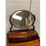 An oval mahogany toilet mirror with string inlay and shell detail