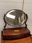 An oval mahogany toilet mirror with string inlay and shell detail