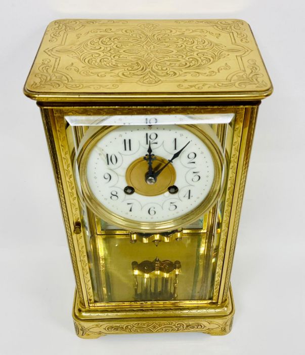 An eight day enamel faced eight day clock in a decorative engraved brass case. - Image 2 of 8