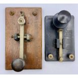 Two Morse code keys, one in Bakelite and the other wooden based.