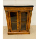 A Mahogany side cabinet with glazed doors to a single shelf, with string inlay and gilt. (60cm x