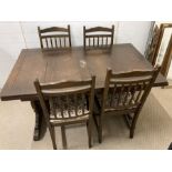 An Ercol dining table with four chairs (H75cm W137cm D84cm)
