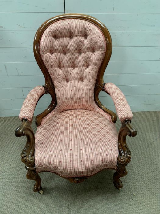 A Victorian button backed walnut armchair