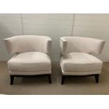 A pair of contemporary semi circular arm chairs with stud details