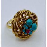 A gold metal and turquoise ring