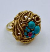 A gold metal and turquoise ring