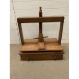 A wooden book/plate press with drawer under (H64cm W65cm D41cm)