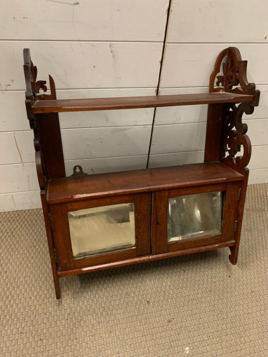 A mahogany wall unit with mirrored doors to front (H74cm W56cm)