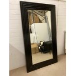 A Large black framed bevel edged mirror (210 cm x 121 cm)