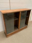 A glazed front bookcase (H82cm W100cm D27cm)