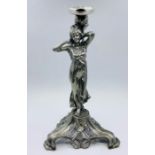 An Art Nouveau style candlestick of a lady signed to base.