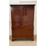 A late Georgian mahogany style linen press, cornice above a pair of panel doors with three long