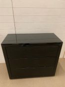 A black glass chest of drawers with faux shagreen chips to top and sides, working order (H88cm W90cm