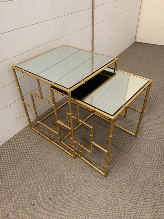 Two nesting mirrored side tables with gilt metal base (Largest 46cm x 40cm)