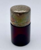 A hallmarked silver topped ruby glass inkwell.