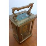 A brass and glass skeleton carriage clock, (10.5x8x6.5 cm).