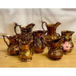 A selection of seven various lustre ware jugs.