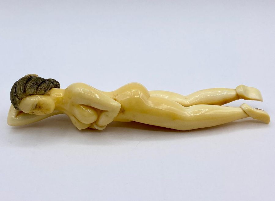An Antique ivory naked lady, style of a doctor model, signed to a foot.
