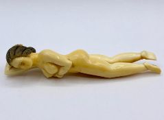 An Antique ivory naked lady, style of a doctor model, signed to a foot.