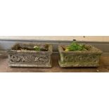 A pair of long reclaimed garden troughs with floral decoration to side