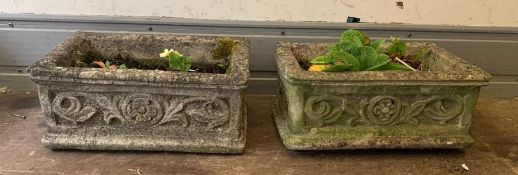 A pair of long reclaimed garden troughs with floral decoration to side