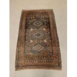 A brown ground carpet/rug (142cm x 85cm)