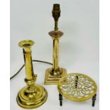 A collection of brass items, including a candlestick, a table lamp and a pot stand