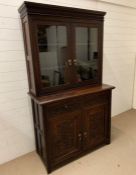 An oak carved dresser with glazed doors to top (H197cm W114cm D52cm)