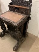 An Anglo-Indian carved Davenport. Writing surface with enclosing drawers, flanked each side with