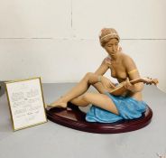 A large boxed Lladro porcelain figure of a semi-clad seated lady playing a lute 'Scheherazade No.