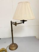 A brass table lamp with swing arm.