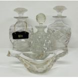 Three clear cut glass decanters and one clear glass dish in a shape of a bird