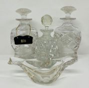 Three clear cut glass decanters and one clear glass dish in a shape of a bird