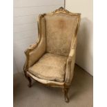 A French Louis XV style high back chair. Gilt frame with scrolled arms (H118cm W67cm SH46cm)