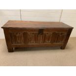 A four panel oak coffer possibly 16th Century with linen fold front (H62cm W149cm D53cm)