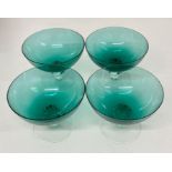 Four vintage green glass bowls on clear stems