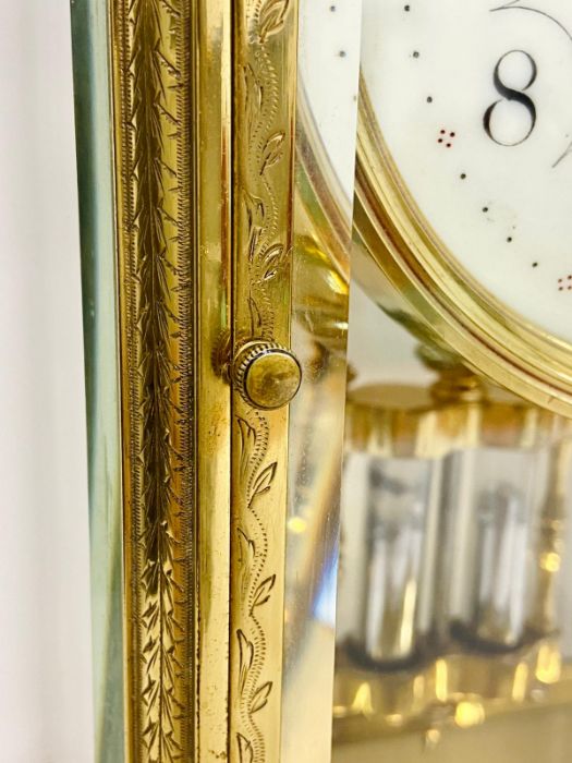 An eight day enamel faced eight day clock in a decorative engraved brass case. - Image 3 of 8