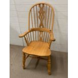 A pine wheel back style kitchen chair