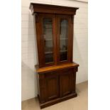 A Victorian mahogany bookcase with two panel glazed doors and two arch panelled doors to cupboard